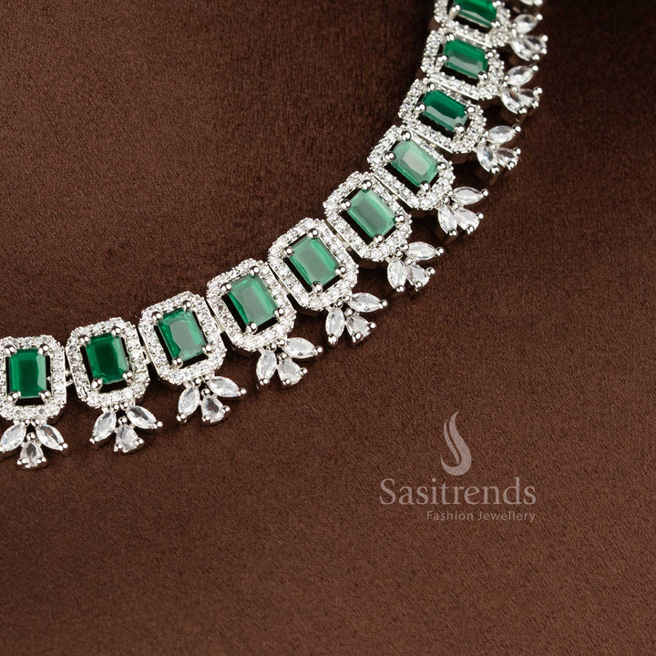 Elegant green American Diamond drop earrings with a floral stud and a rectangular emerald-green stone centerpiece in a rhodium silver finish 2021C - Sasitrends