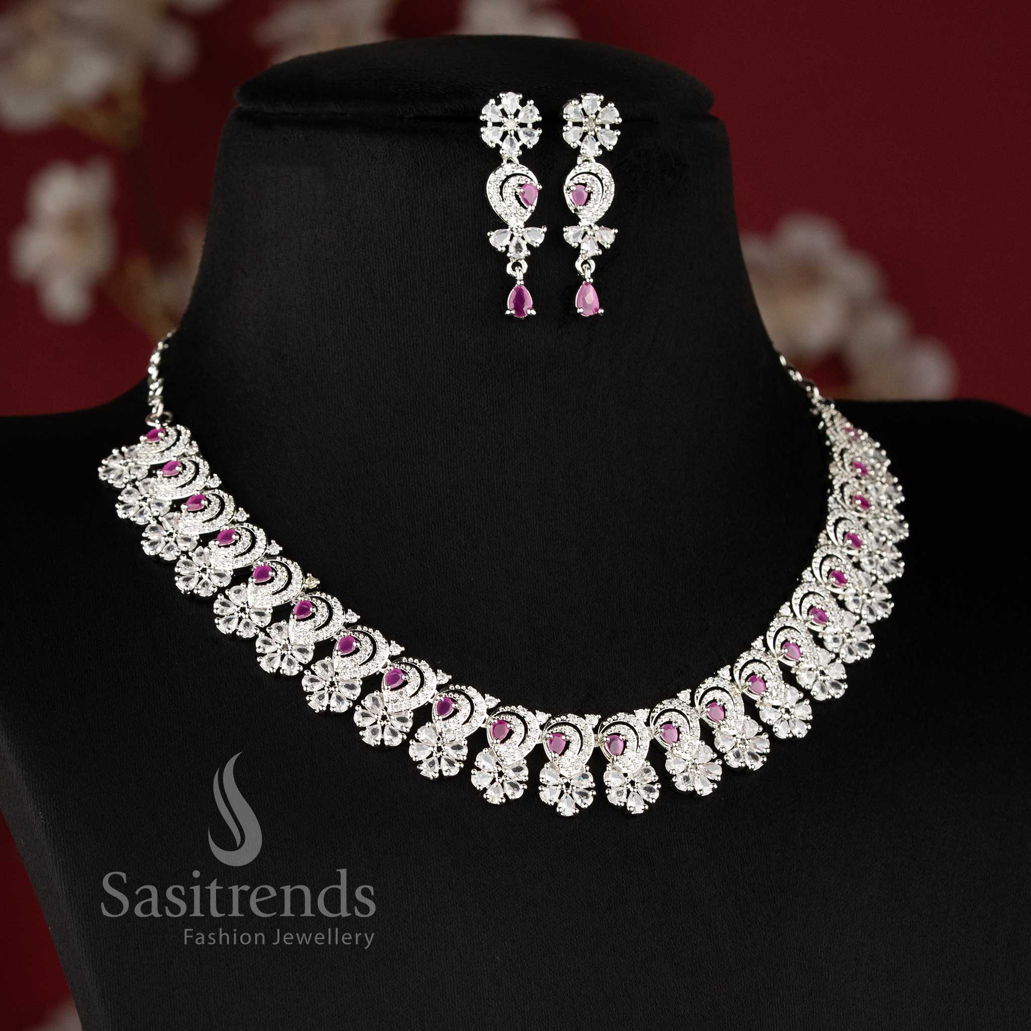 "Ruby color rhodium silver plated floral necklace set with sparkling American diamond stones for party wear - Sasitrends