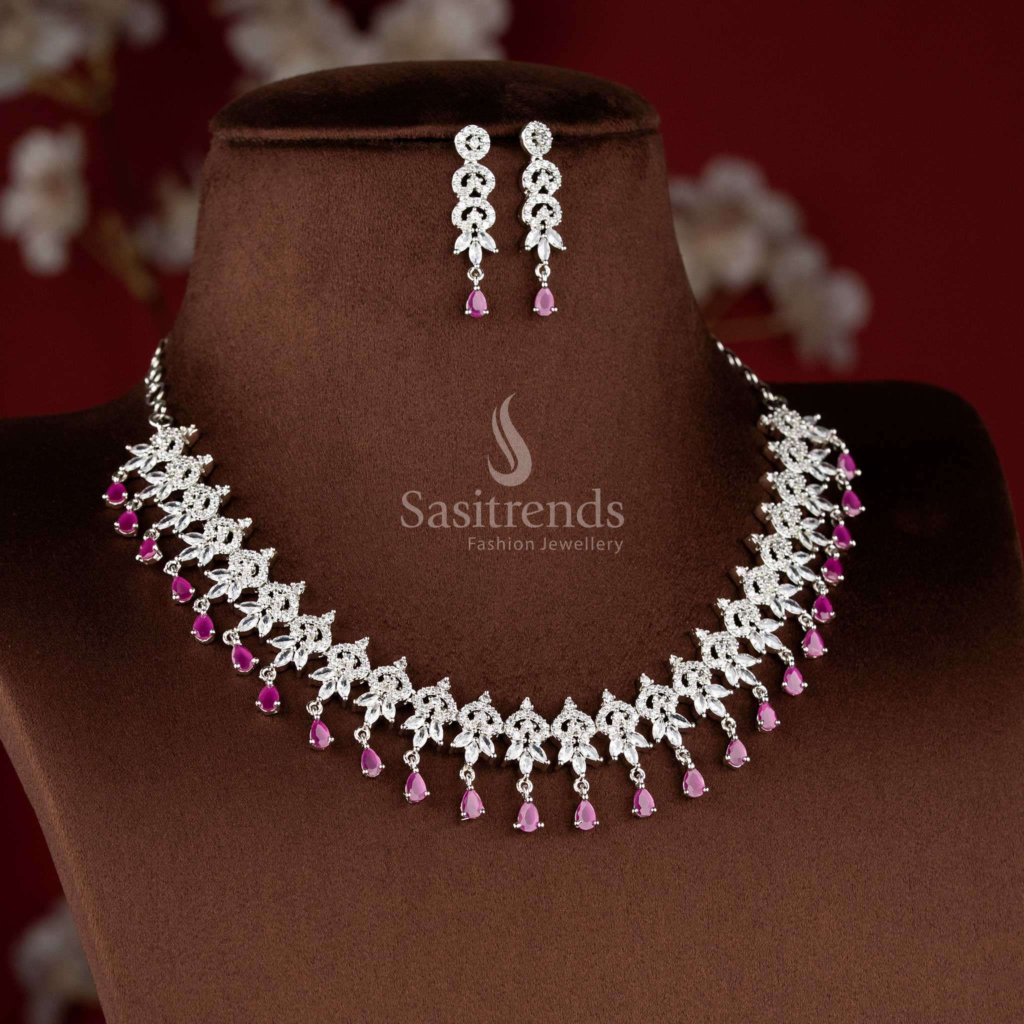 Ruby color rhodium plated floral cluster American diamond necklace set with teardrop danglers for bridal wear - sasitrends