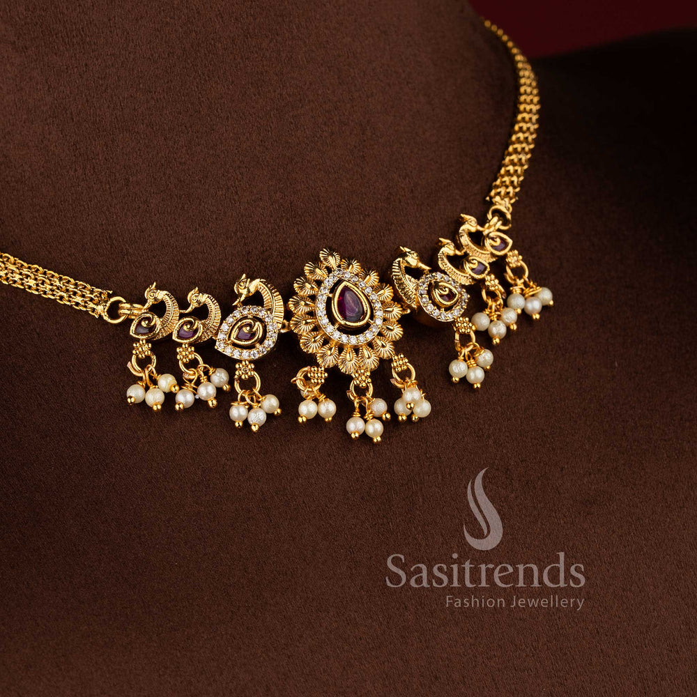  Traditional matte gold plated peacock choker necklace set with jhumkas and AD stones in ruby white by Sasitrends.
