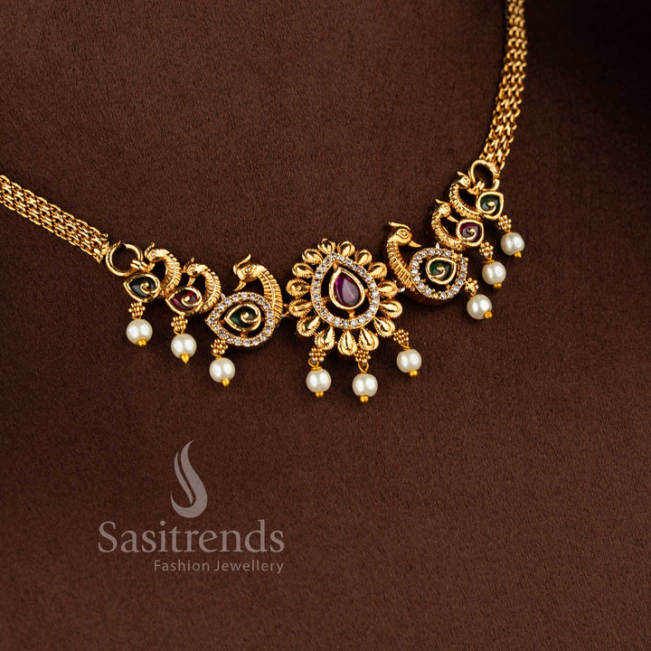 Traditional matte gold plated peacock choker necklace set with jhumkas and AD stones in ruby green by Sasitrends.