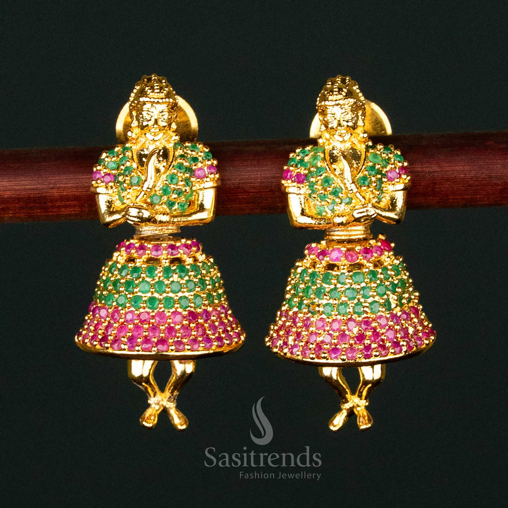 Elegant ruby-green American Diamond gold-plated brass jhumka earrings, deity-inspired traditional festive wear with intricate craftsmanship - Sasitrends