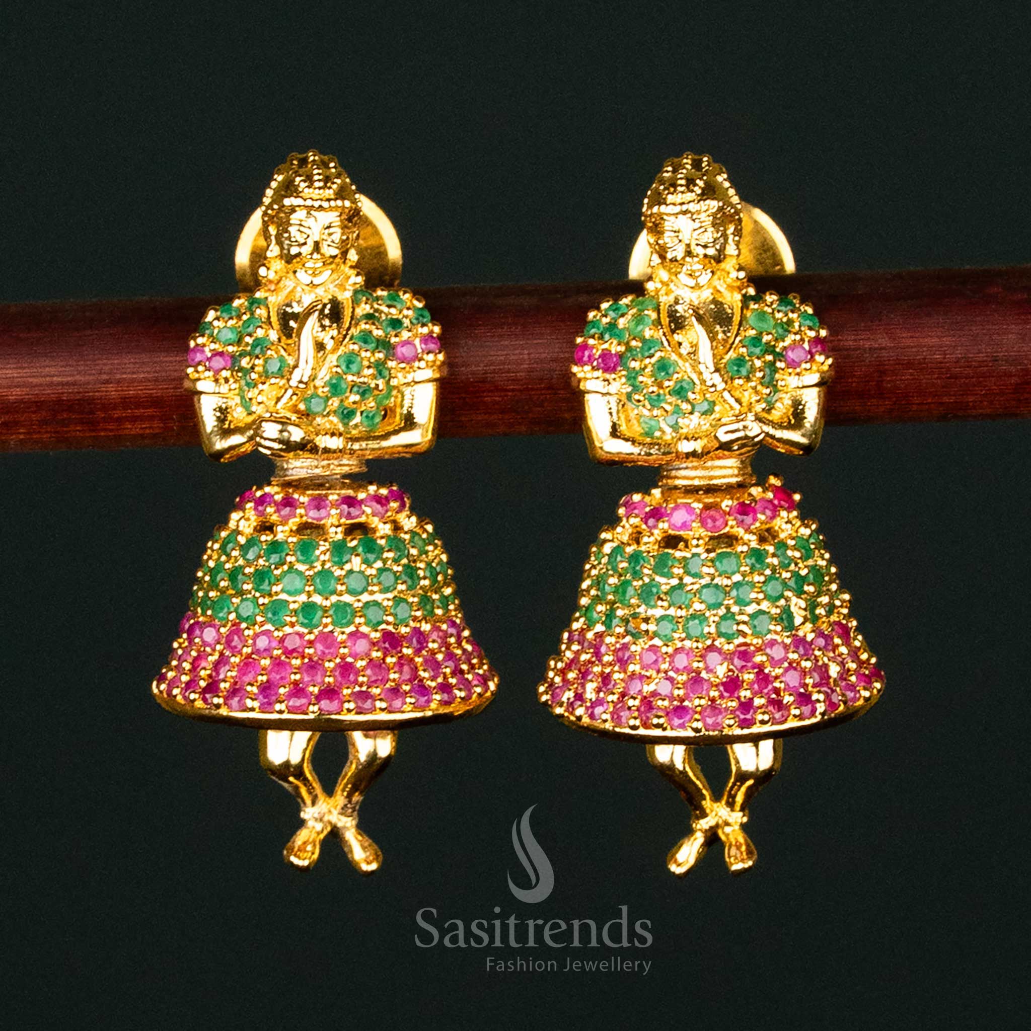 Elegant ruby-green American Diamond gold-plated brass jhumka earrings, deity-inspired traditional festive wear with intricate craftsmanship - Sasitrends