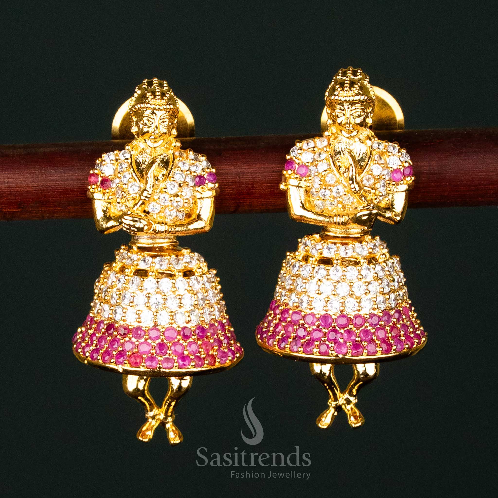 Stunning white-ruby American Diamond gold-plated brass jhumka earrings, ideal for bridal and grand traditional occasions - Sasitrends