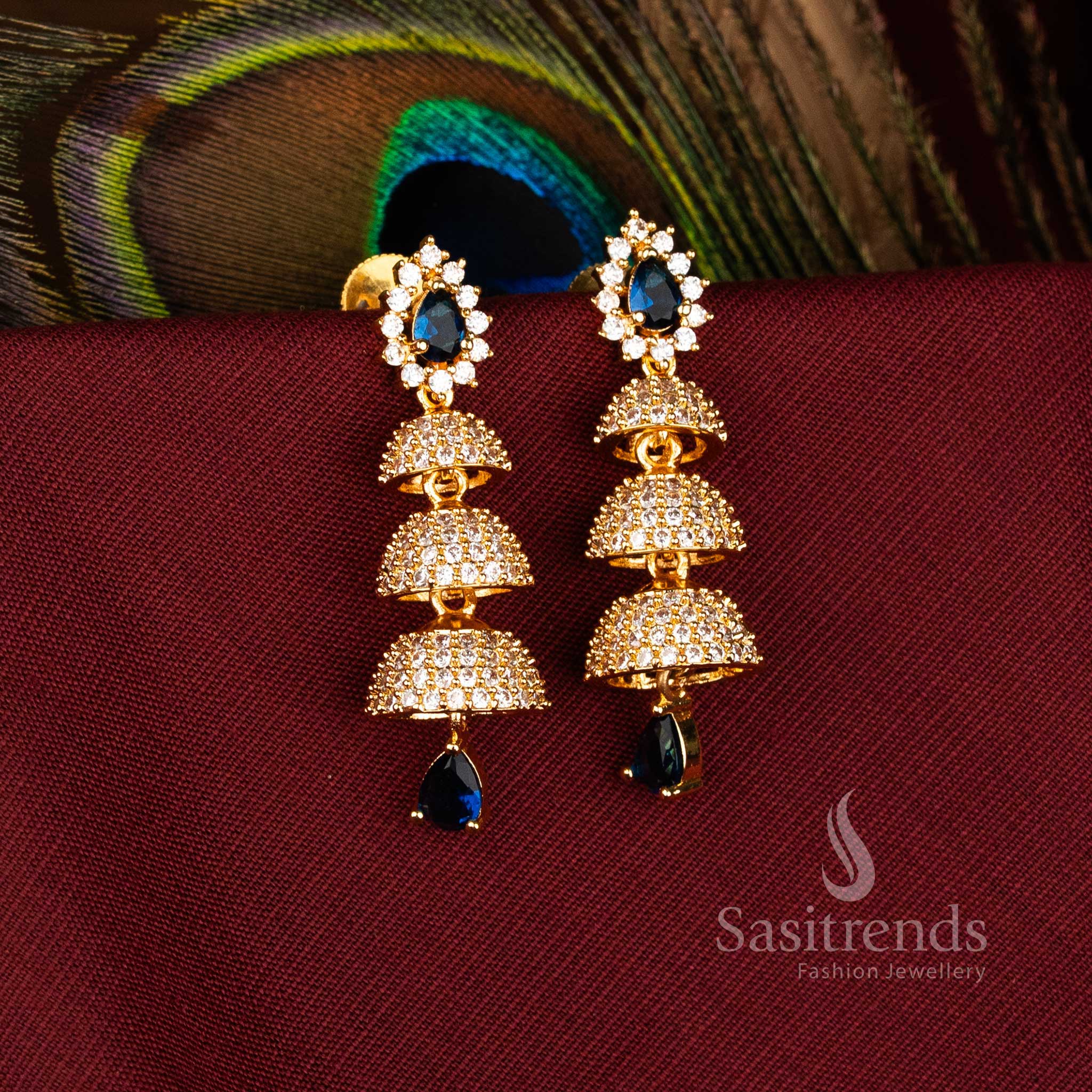Elegant Triple Tier Bell Gold Plated Brass Jhumka Earrings with American Diamonds for Festive Wear – Sasitrends