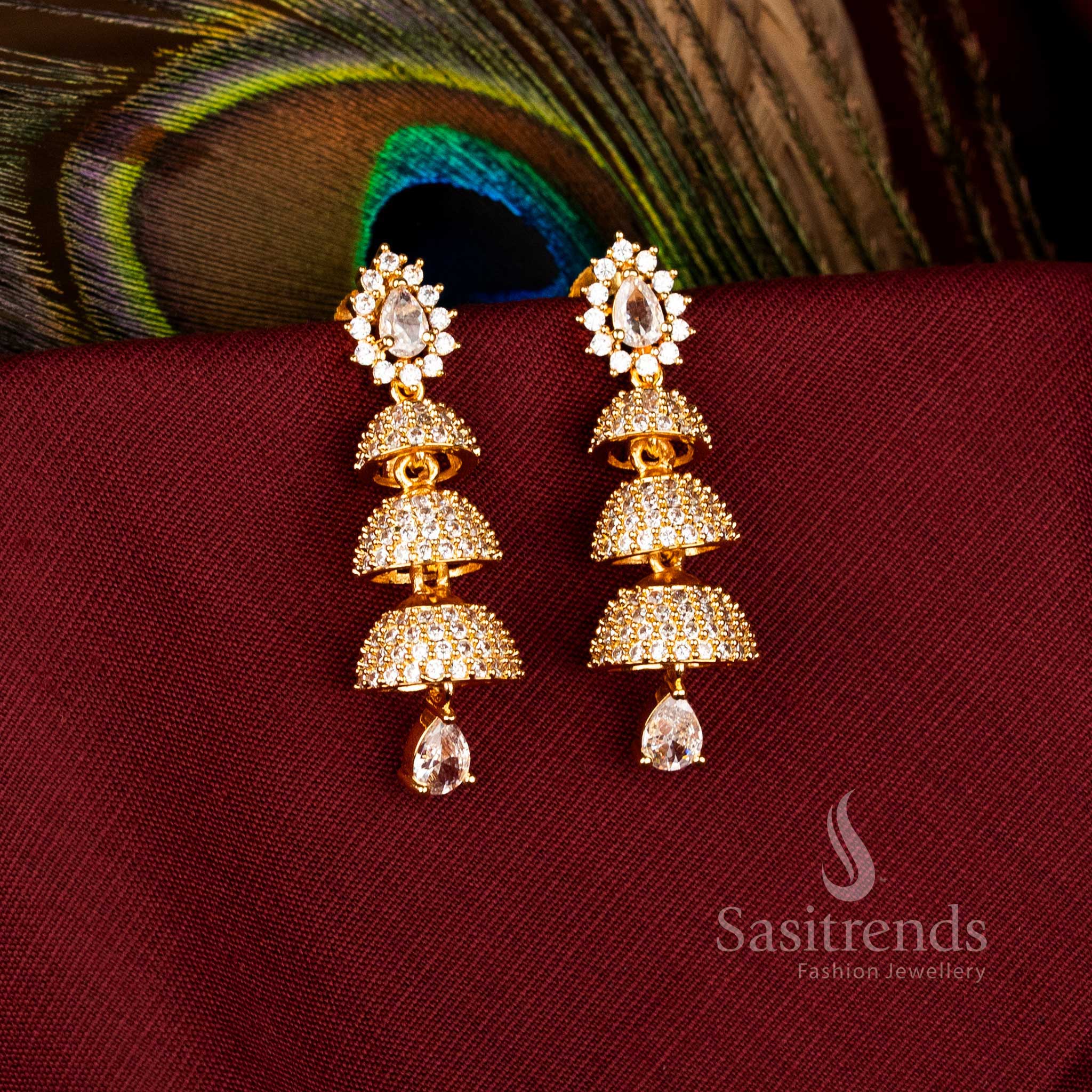 Elegant Triple Tier Bell Gold Plated Brass Jhumka Earrings with American Diamonds for Festive Wear – Sasitrends