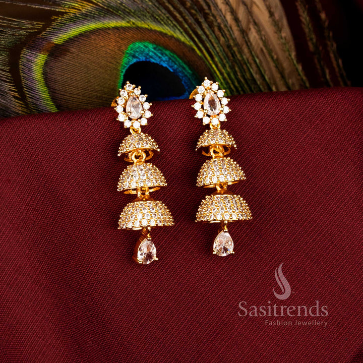 Elegant Triple Tier Bell Gold Plated Brass Jhumka Earrings with American Diamonds for Festive Wear – Sasitrends