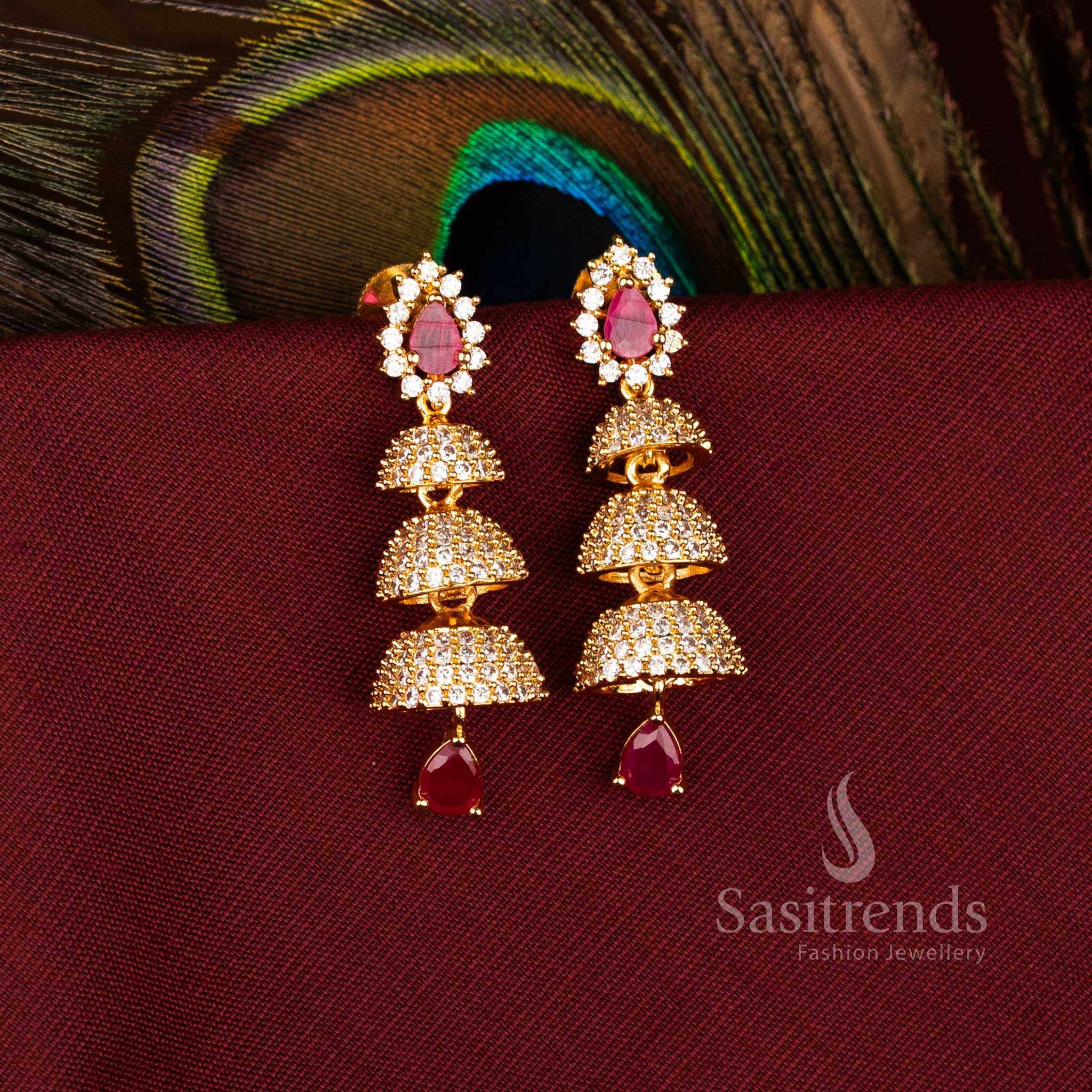 Elegant Triple Tier Bell Gold Plated Brass Jhumka Earrings with American Diamonds for Festive Wear – Sasitrends