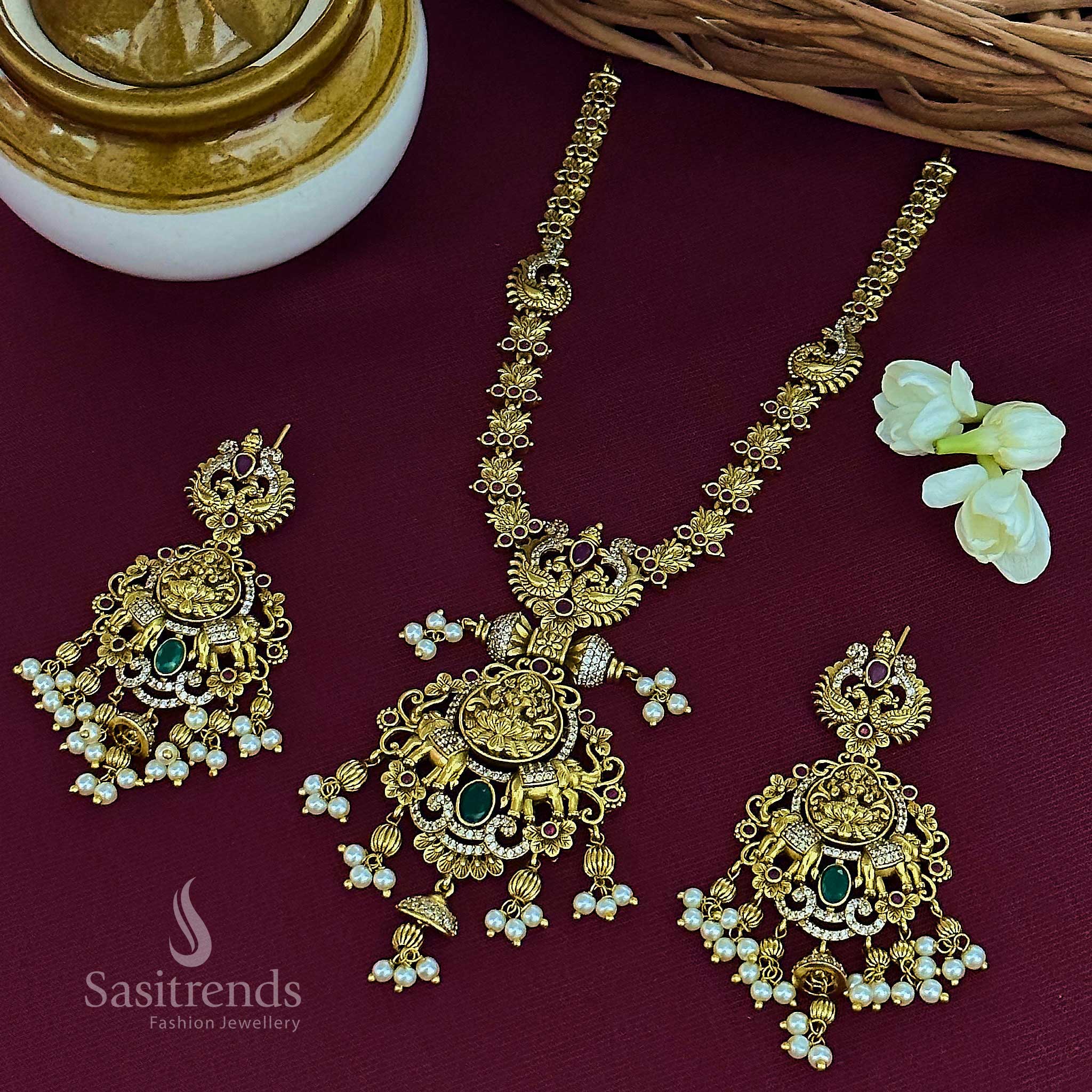Royal bridal ruby-green Lakshmi elephant pendant temple matte gold plated jewellery set adorned with glorious AD stones and festive jhumkas, ideal for traditional ceremonies – Sasitrends