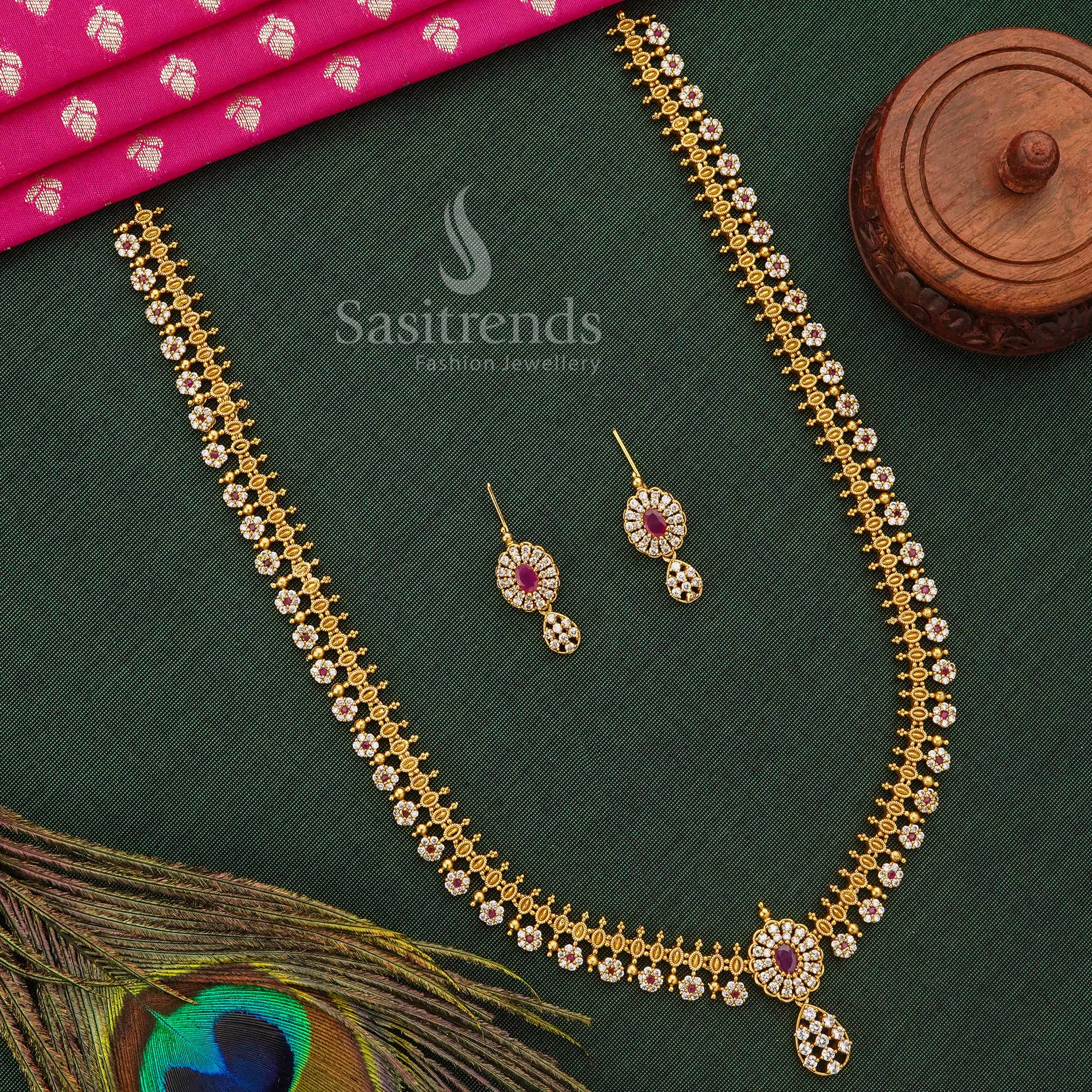 Graceful Temple Matte Gold Long Jewellery Set Adorned With White-Ruby AD Stones And Floral Motifs, Perfect Traditional Accessory For Festivals And Sarees – Sasitrends