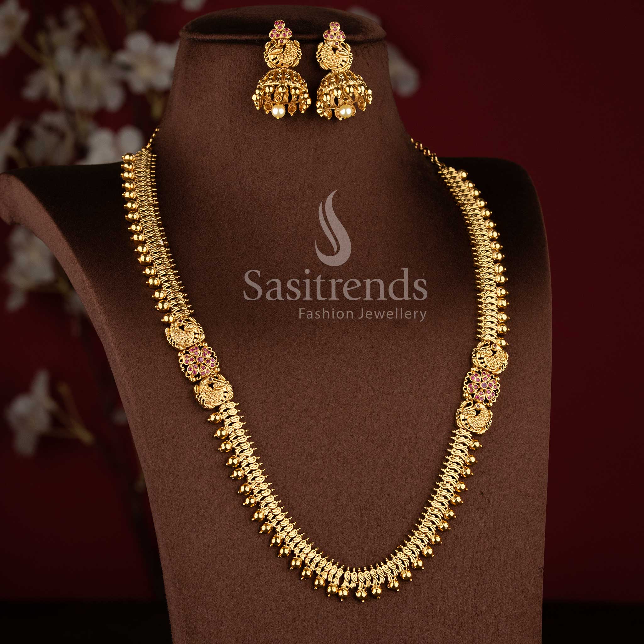 Bridal matte gold peacock design long necklace set with AD stones and jhumkas in ruby color