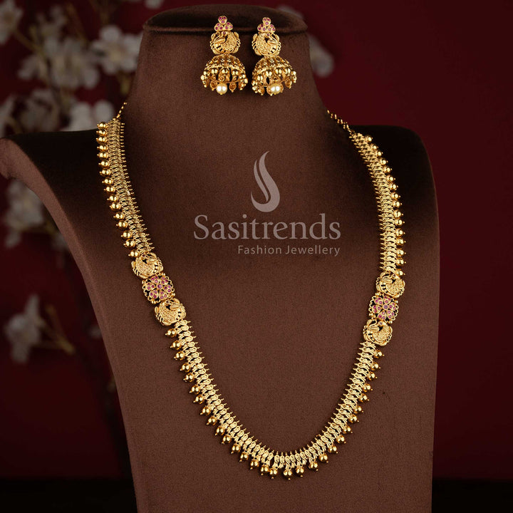 Bridal matte gold peacock design long necklace set with AD stones and jhumkas in ruby color
