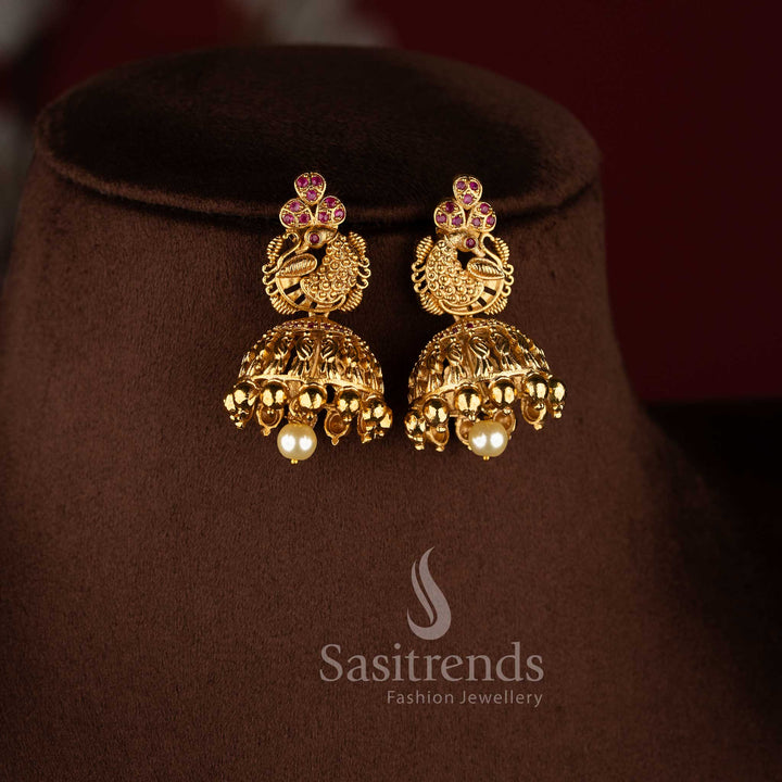 Temple matte gold peacock floral long haram necklace set with ruby stones and jhumkas.