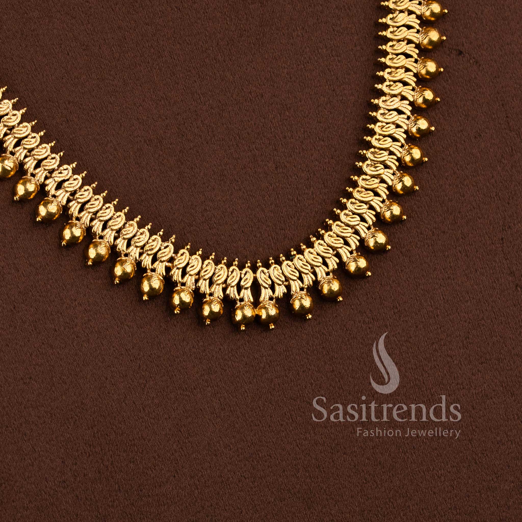 Bridal matte gold peacock design long necklace set with AD stones and jhumkas in ruby color