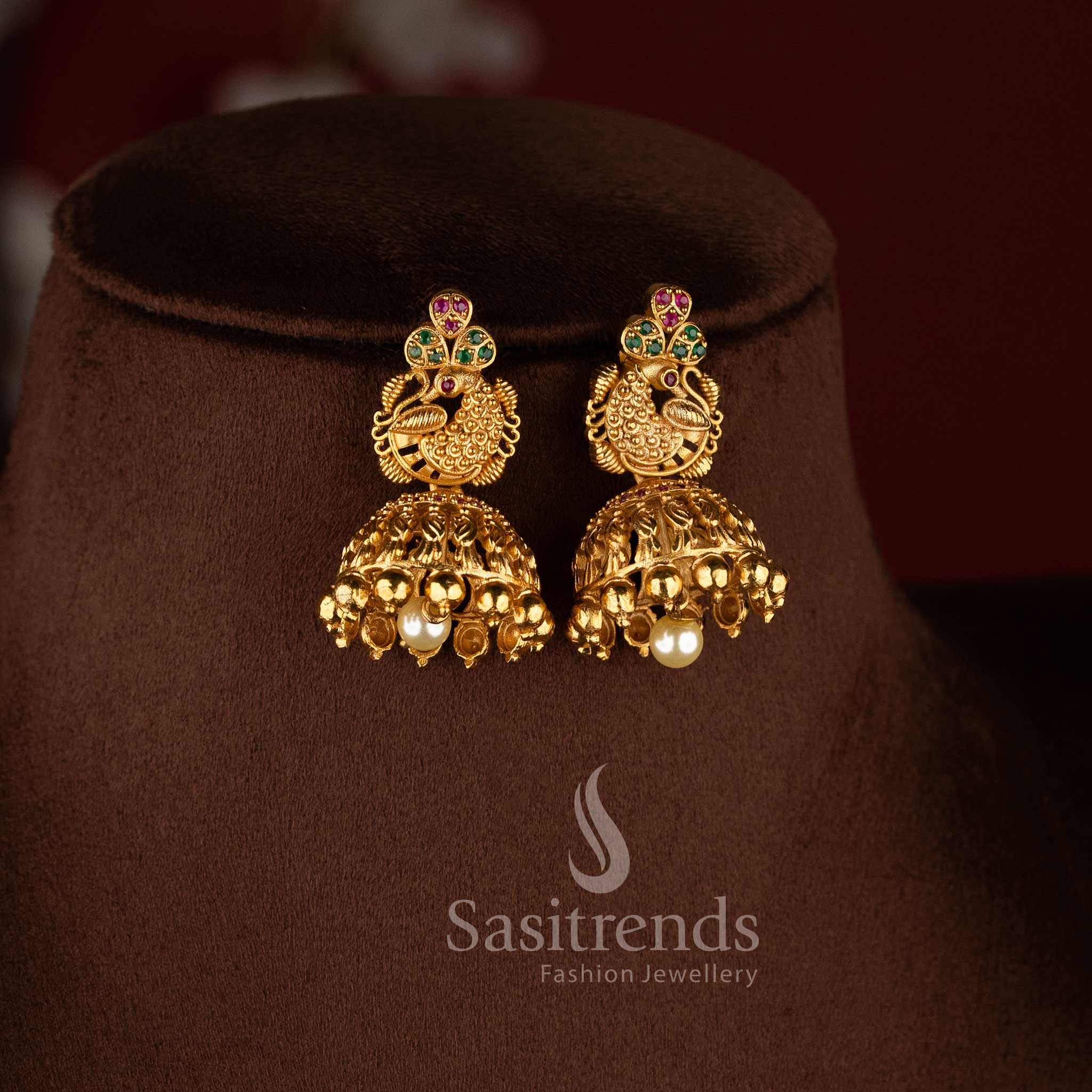 Temple matte gold peacock floral long haram necklace set with ruby green stones and jhumkas.
