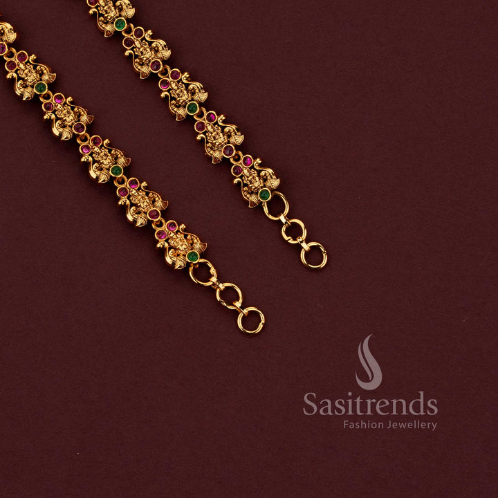 Temple matte gold plated Lakshmi floral matil ear chain with ruby green stones by Sasitrends.