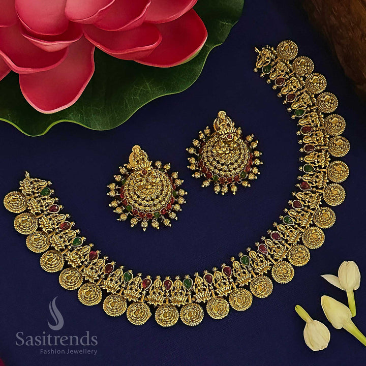Traditional South Indian ruby-green matte gold plated temple jewellery set with peacock and Lakshmi coin motifs, featuring regal finish jhumkas and ethnic antique charm by Sasitrends