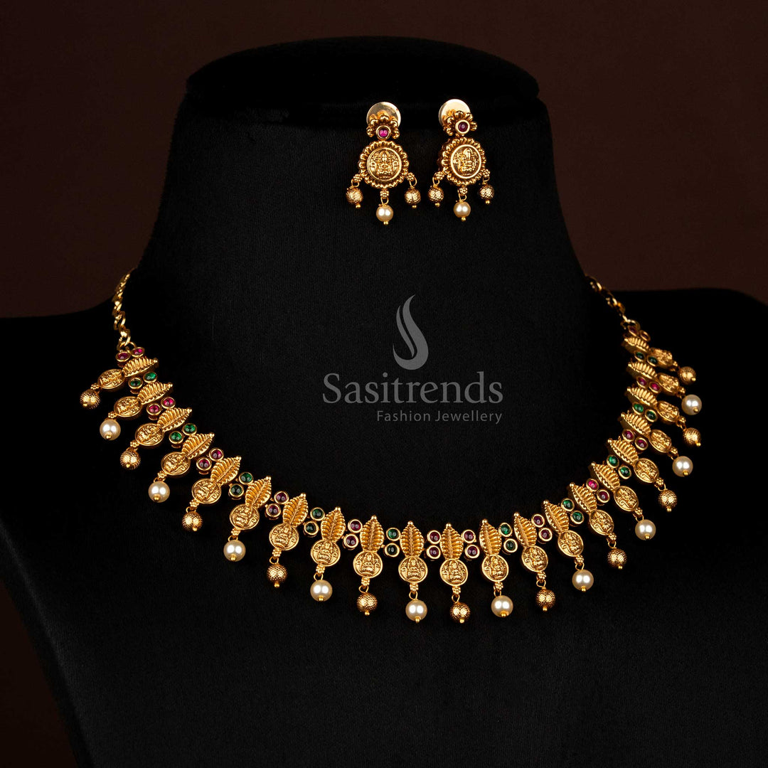 Regal Matte Gold Plated Necklace with Leaf Fringes, Lakshmi Motifs, AD Stones, Pearls, and Beads by Sasitrends