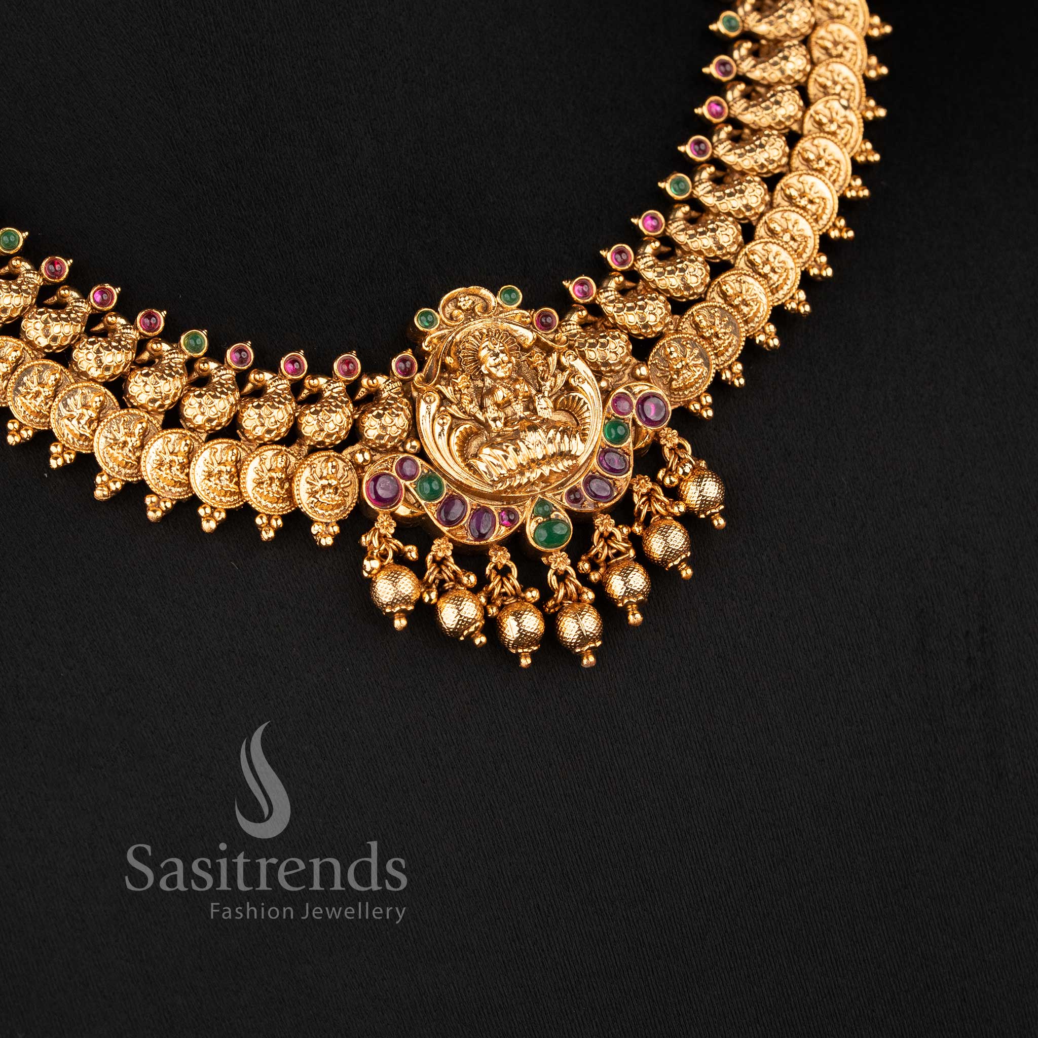 Close-up of the Lakshmi deity pendant accented with ruby and emerald kemp stones and a fringe of polished gold beads 2073B - Sasitrends