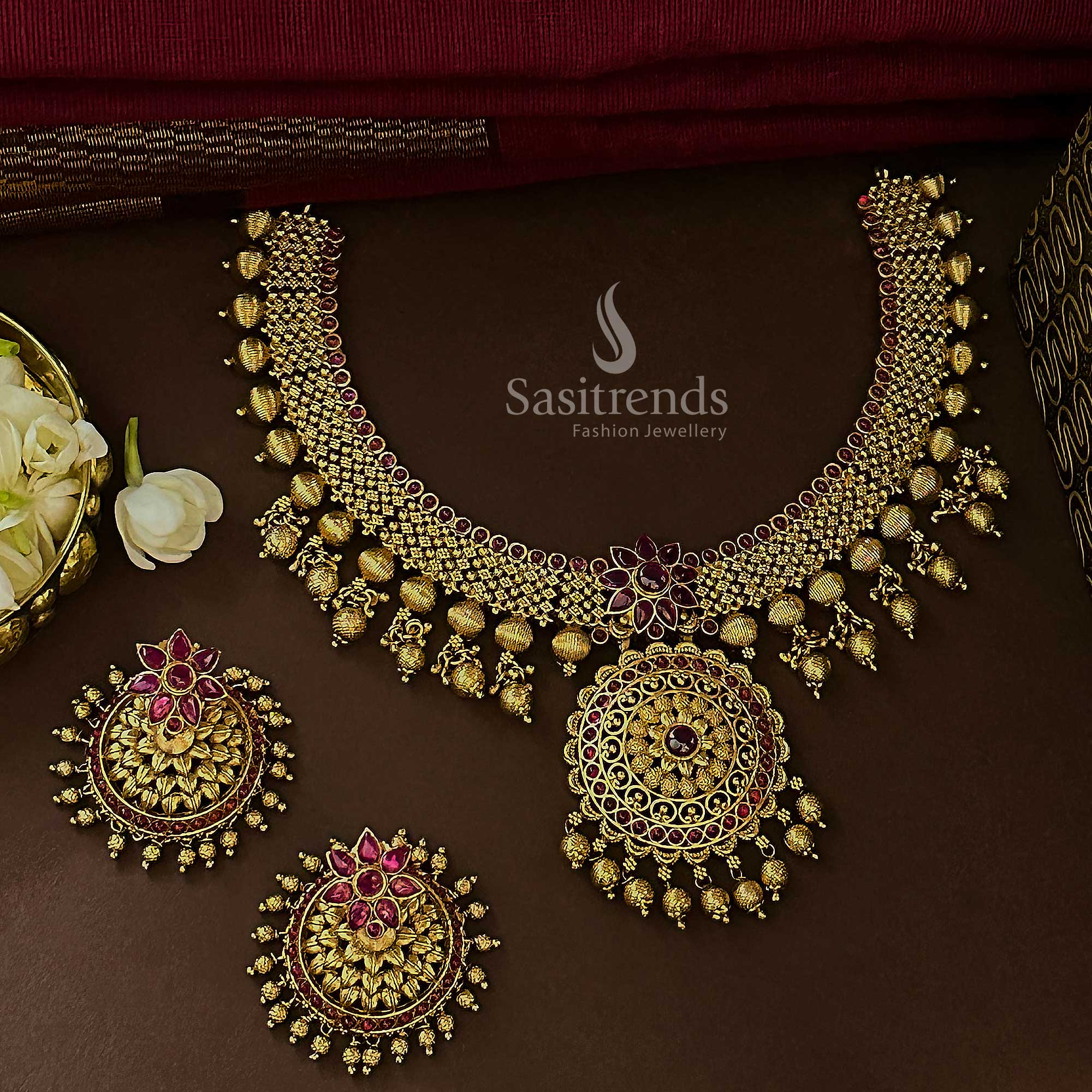 Royal ruby bridal floral jewellery set with matte gold temple plating, ethereal AD stones, and ornamental blossoms made for classic festive glamour – Sasitrends