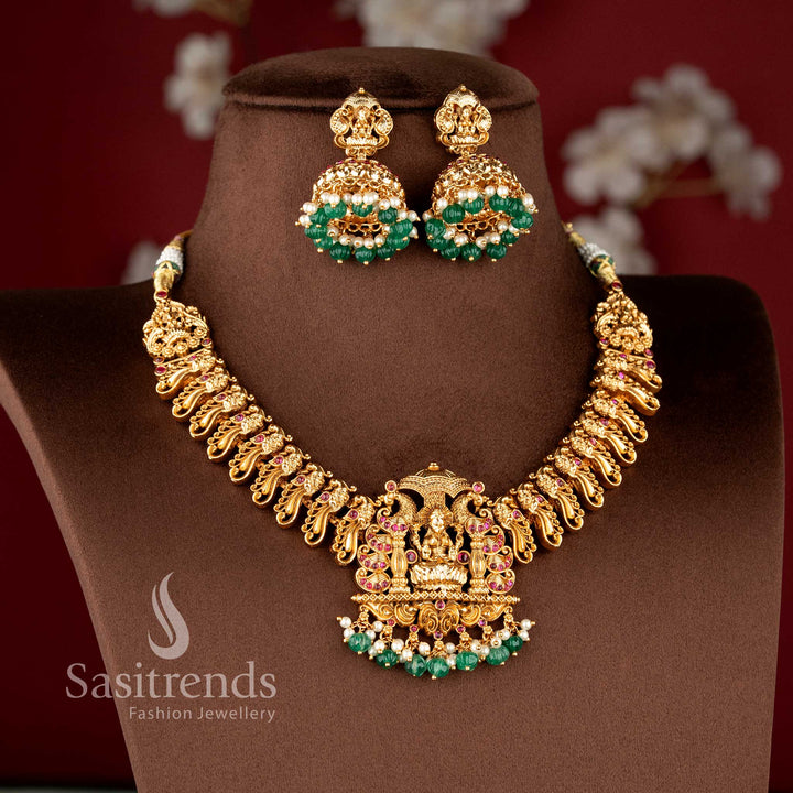 Wedding special temple style necklace set with ruby stones lakshmi motif pendant and classic south indian craftsmanship sasitrends