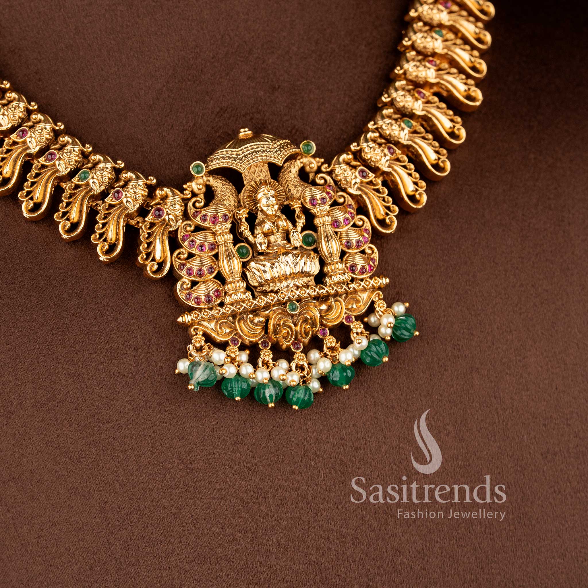 ethnic matte finish temple jewellery set with ruby green stones lakshmi pendant and traditional jhumkas for wedding wear sasitrends