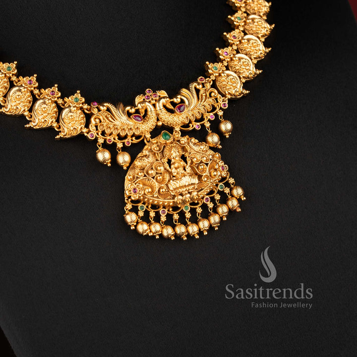 Temple matte gold plated lakshmi peacock bridal necklace set with ruby and green stones and grand pendant for wedding wear sasitrends
