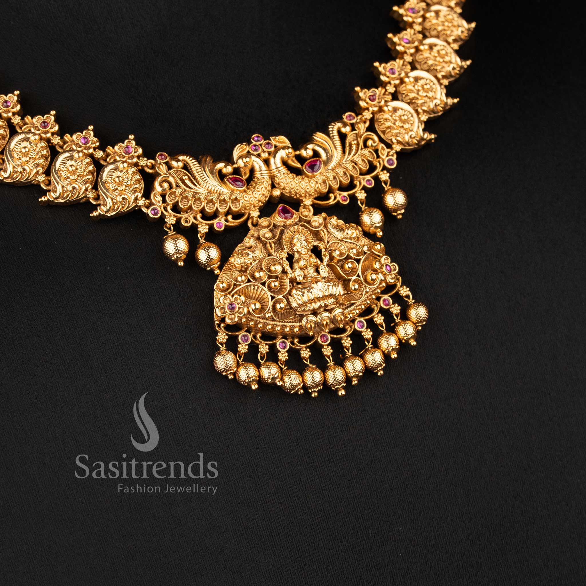 temple matte gold plated lakshmi peacock bridal necklace set with ruby stones and grand pendant for wedding wear sasitrends