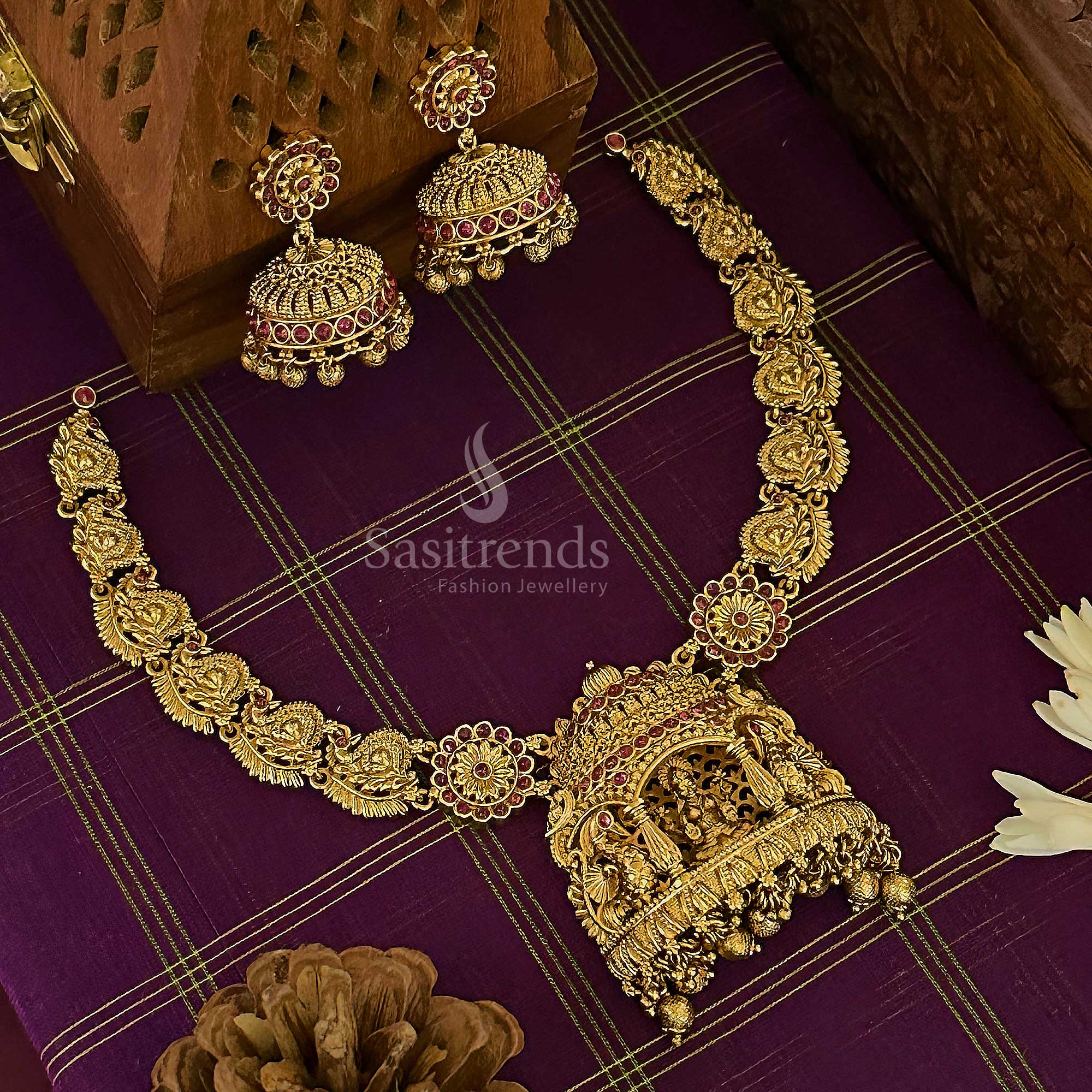 Grand bridal temple choker jewellery set with a majestic matte gold finish, featuring Lakshmi and peacock motifs, highlighted with deep ruby stones for an authentic South Indian wedding ensemble – sasitrends