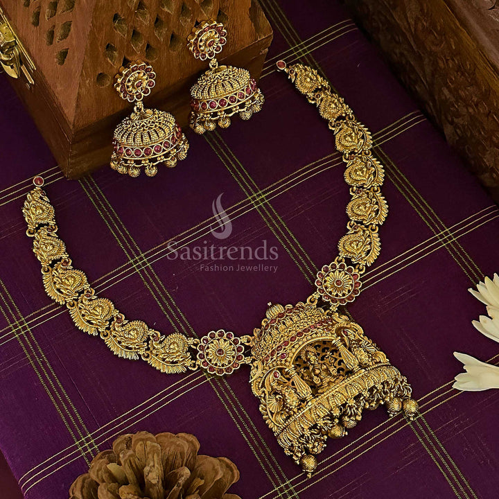 Grand bridal temple choker jewellery set with a majestic matte gold finish, featuring Lakshmi and peacock motifs, highlighted with deep ruby stones for an authentic South Indian wedding ensemble – sasitrends