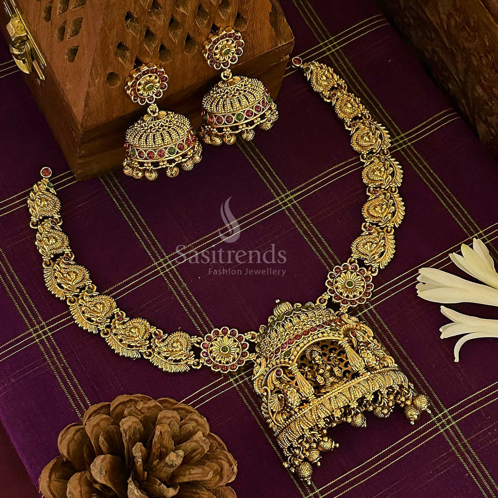 Heritage matte gold bridal choker set showcasing dual-shade ruby-green stones with intricate Lakshmi and peacock motifs, a statement of exquisite temple jewellery craftsmanship – sasitrends