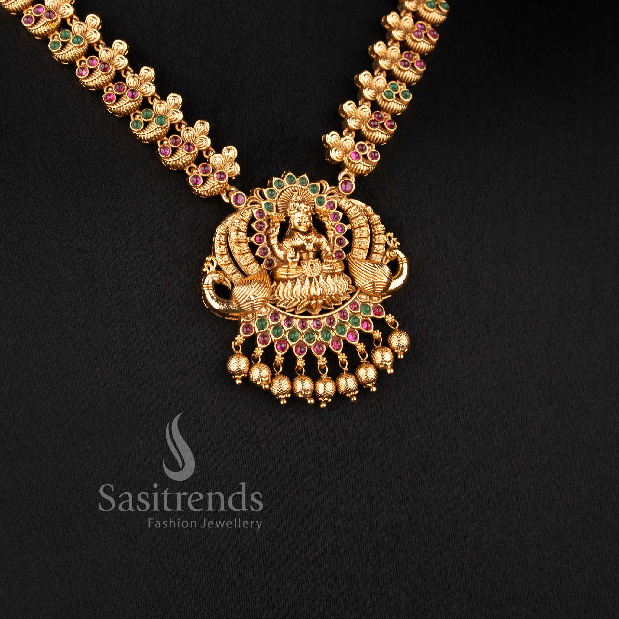 Matching temple-style jhumkas with deity studs and bell-shaped domes from the temple jewellery for wedding collection - Sasitrends