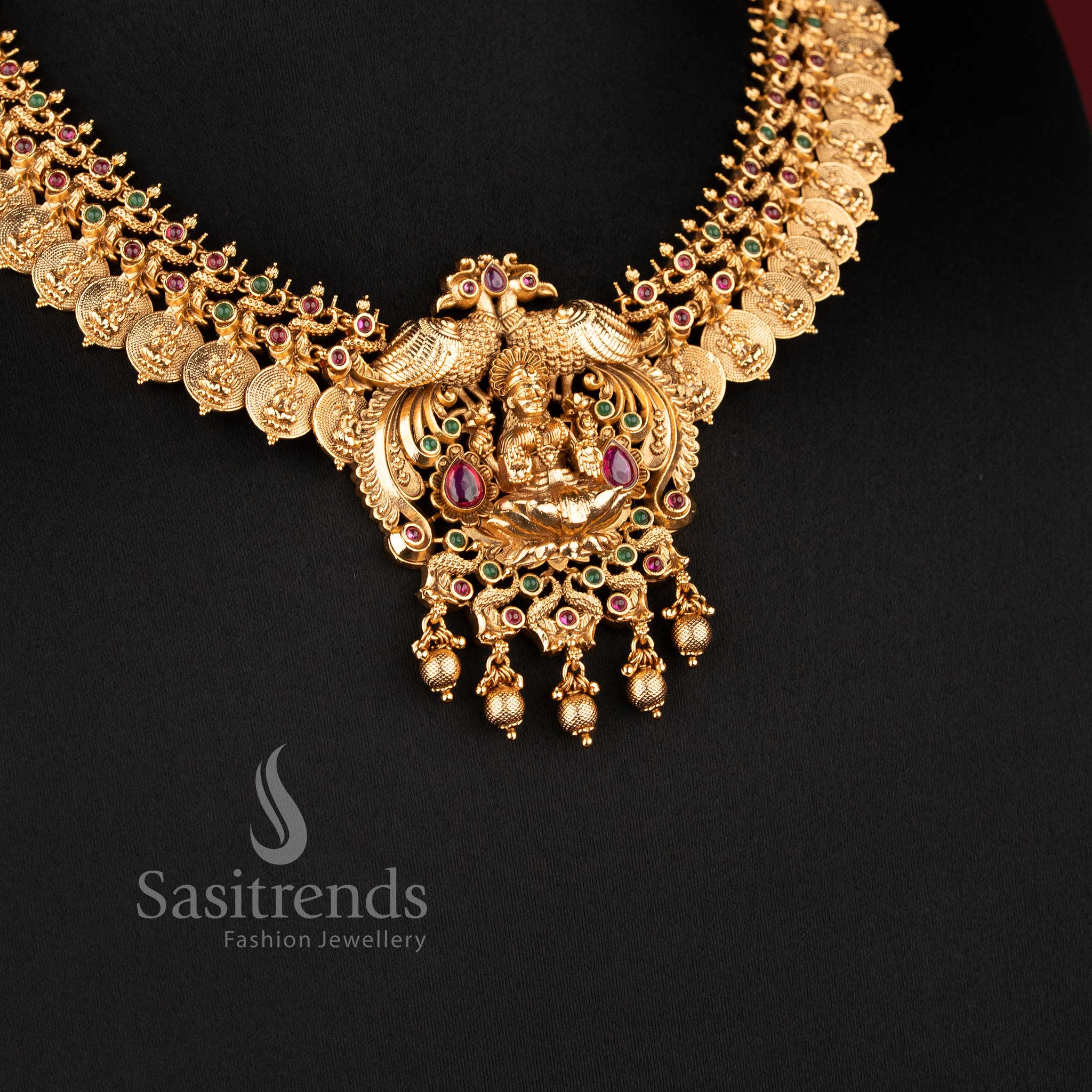 Elegant temple jewellery set in ruby green color featuring Nakshi carved Lakshmi peacock choker necklace, ideal for bridal lehenga saree festive occasions