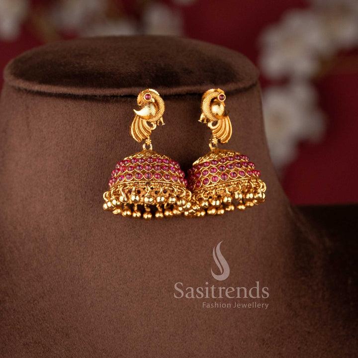 Matching peacock-stud jhumkas with ruby-encrusted domes and gold bead drops from the temple jewellery for wedding collection - Sasitrends