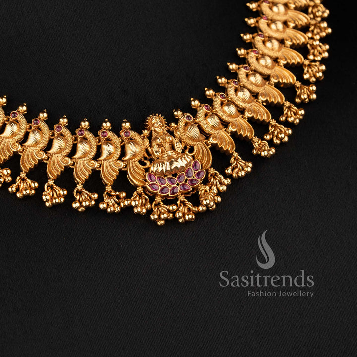 Close-up of the Bridal Jewellery Set showing the intricate dancing peacock engravings and ruby kemp stone accents in a matte gold finish - Sasitrends