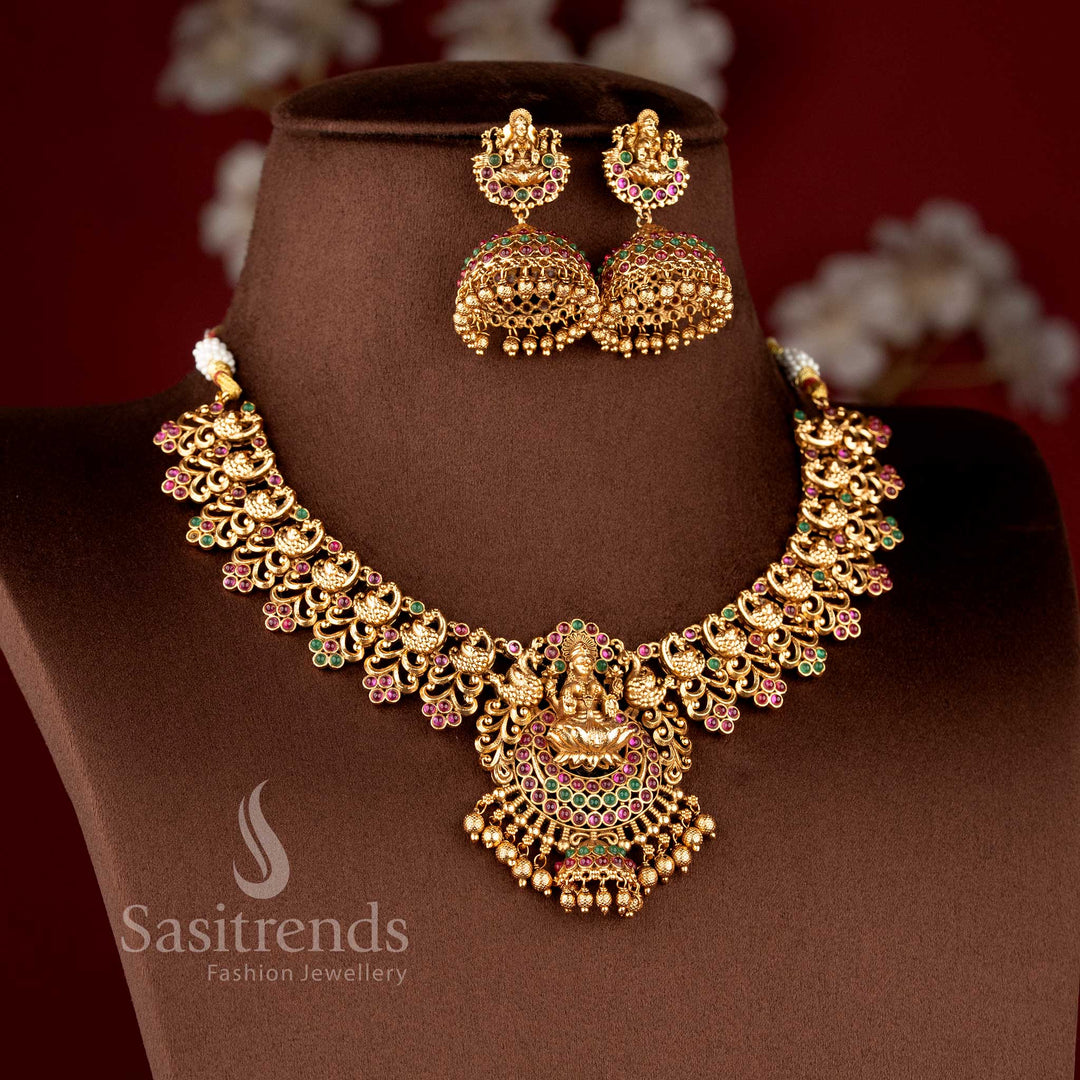 Grand Temple Jewellery Set for brides featuring a seated Lakshmi pendant with a unique mini-jhumka drop and peacock cluster links - Sasitrends