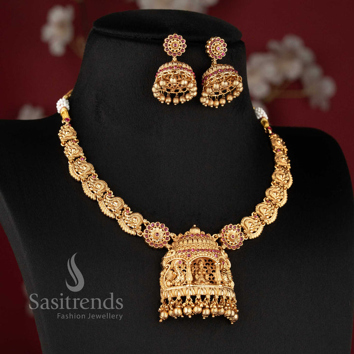 Heavy bridal temple matte gold finish Nakshi choker necklace with Lakshmi peacock design and rich ruby green stone embellishments
