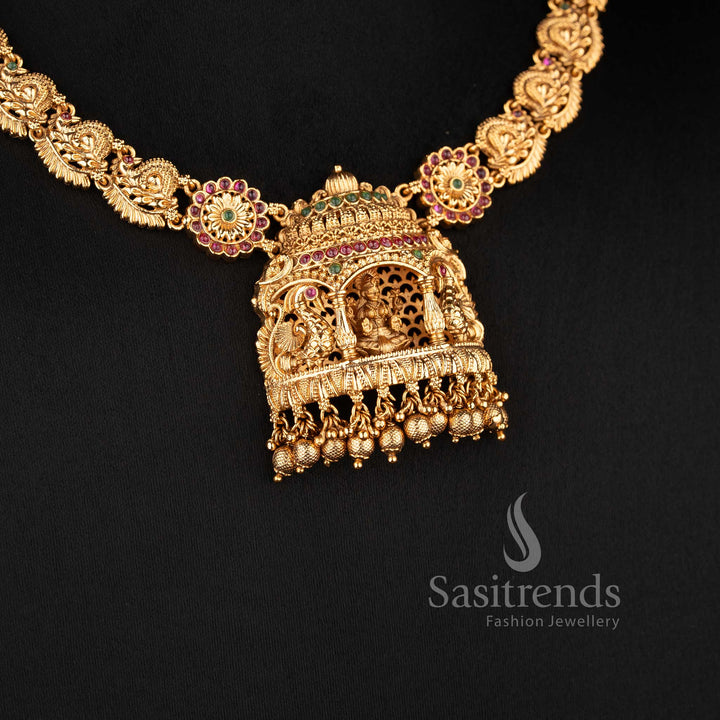 Grand bridal temple matte gold Nakshi style choker necklace with Lakshmi and peacock design, adorned with ruby stones for traditional bridal look