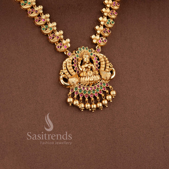Traditional bridal wear temple matte gold tone Lakshmi and peacock haram necklace jewellery set in ruby green  color with matching jhumkas by Sasitrends, perfect for wedding and festive occasions