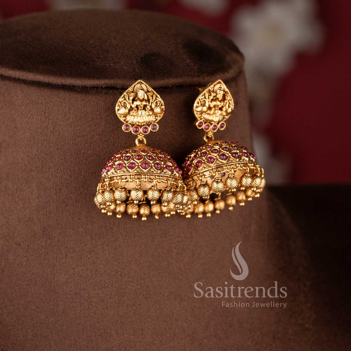 Traditional bridal wear temple matte gold tone Lakshmi and peacock haram necklace jewellery set in ruby color with matching jhumkas by Sasitrends, perfect for wedding and festive occasions - Sasitrends