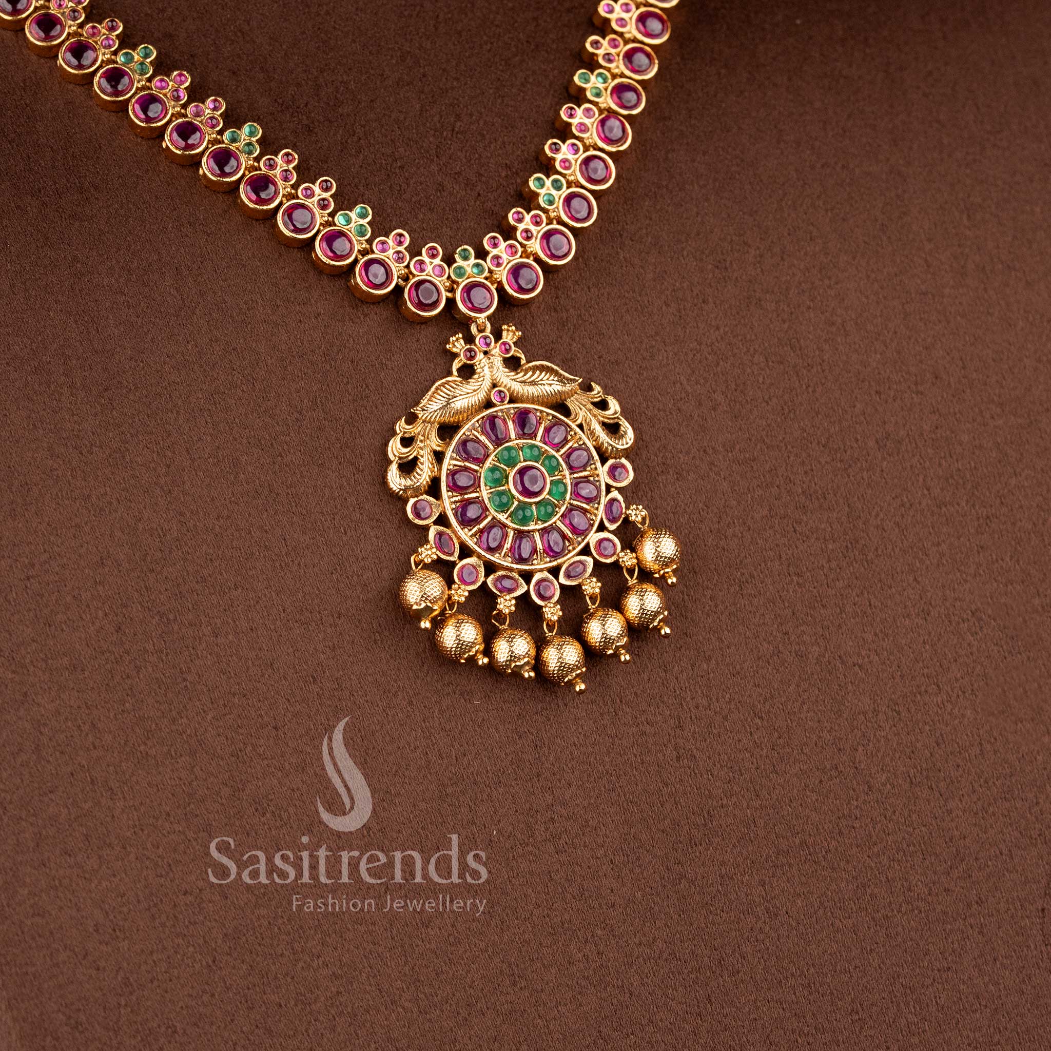 Traditional Nakshi style temple jewellery set with ruby Kemp peacock necklace in matte gold finish by Sasitrends for saree and bridal wear