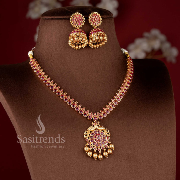Traditional Nakshi style temple jewellery set with ruby Kemp peacock necklace in matte gold finish by Sasitrends for saree and bridal wear