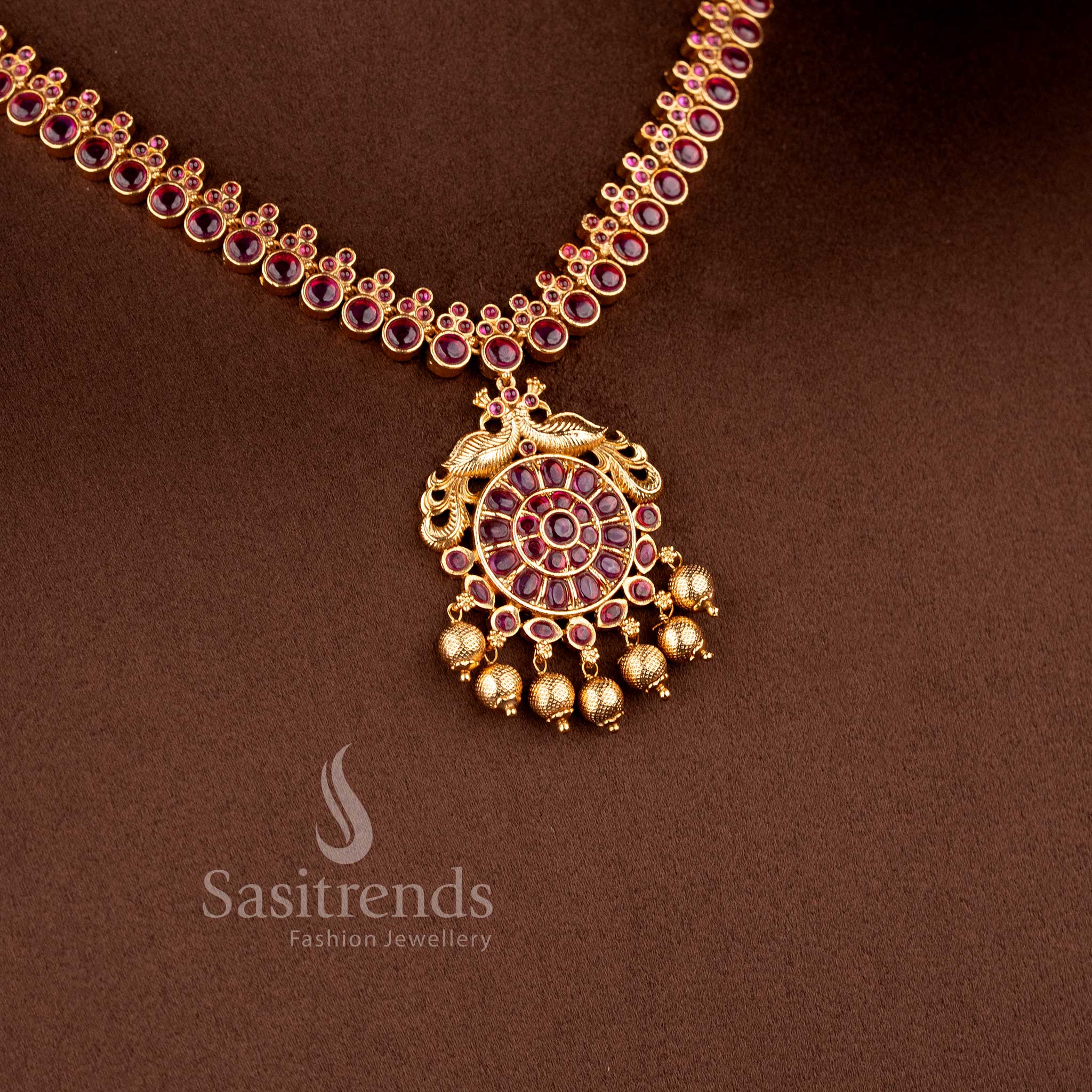 Grand bridal temple jewellery necklace set with ruby Kemp and peacock design in matte gold tone by Sasitrends, perfect for lehenga and festive occasions