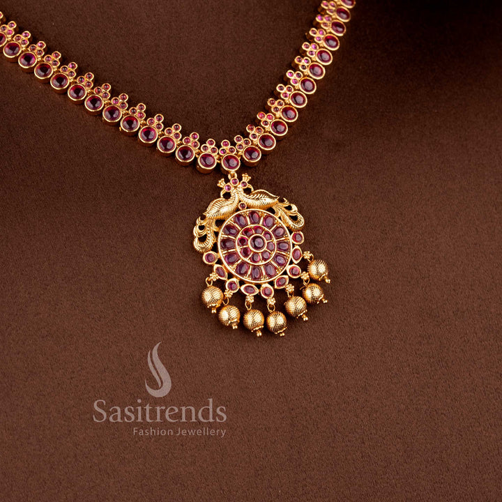 Grand bridal temple jewellery necklace set with ruby Kemp and peacock design in matte gold tone by Sasitrends, perfect for lehenga and festive occasions