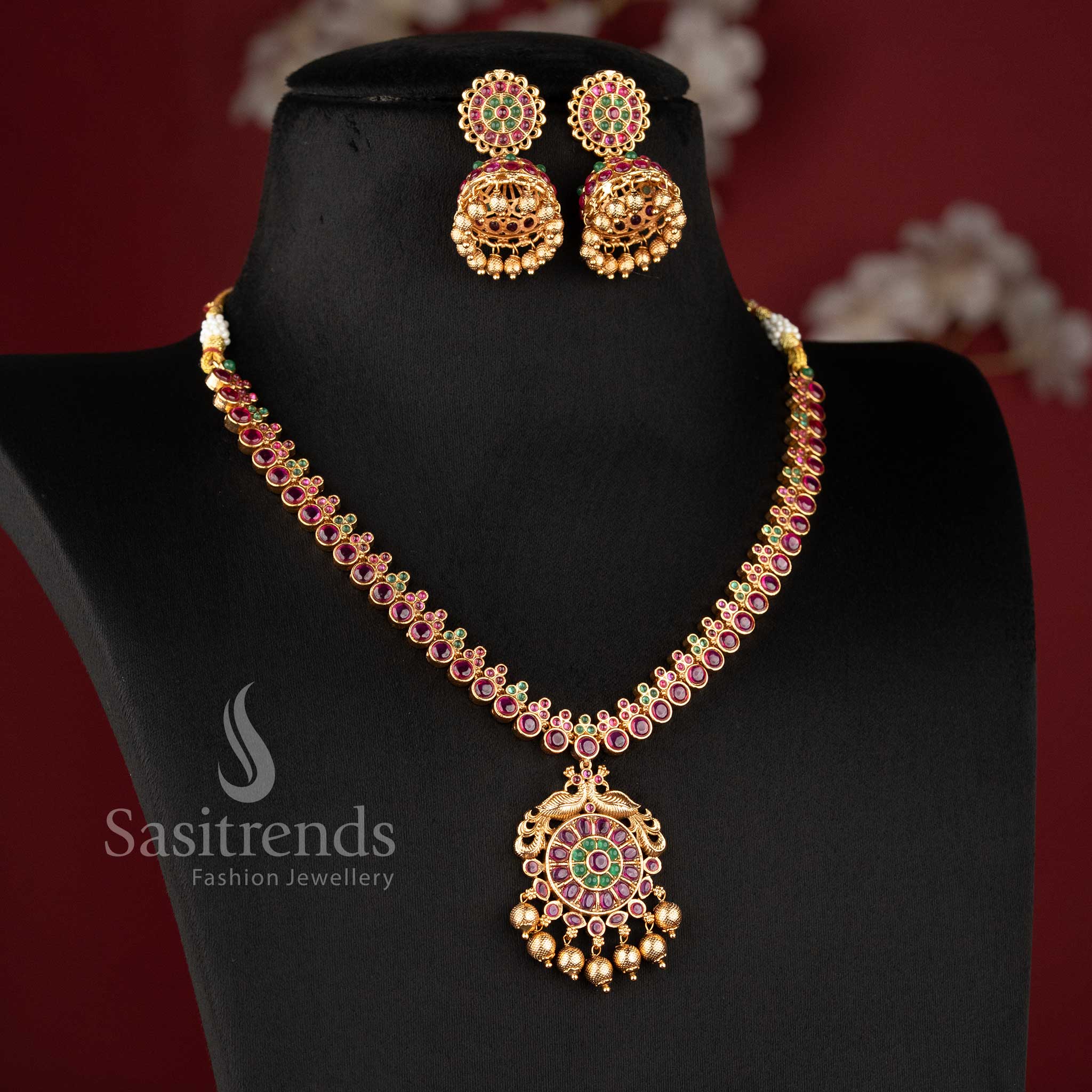 Elegant South Indian bridal temple jewellery set featuring ruby Kemp peacock necklace in matte gold finish by Sasitrends for traditional wear