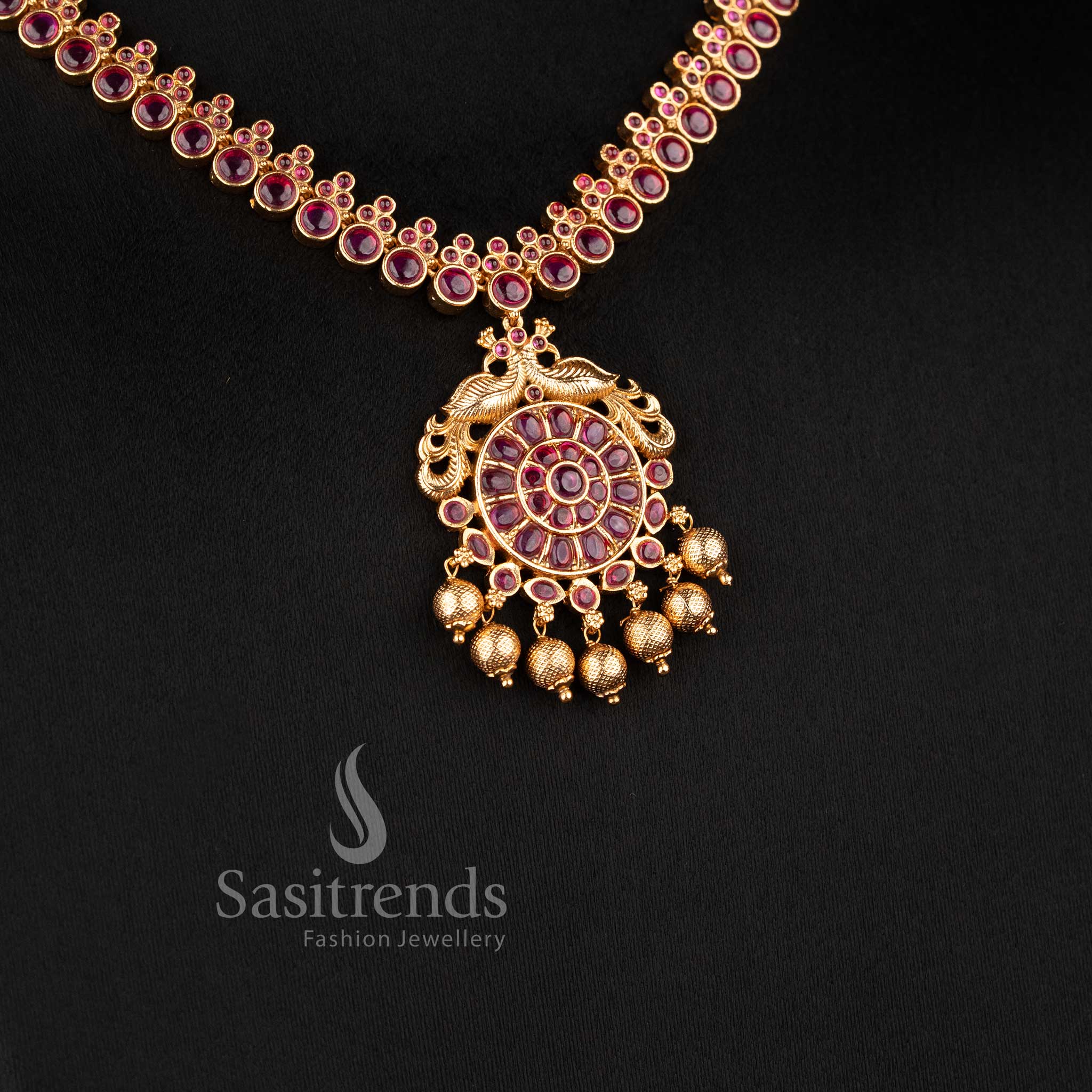 Elegant South Indian bridal temple jewellery set featuring ruby peacock necklace in matte gold finish by Sasitrends for traditional wear