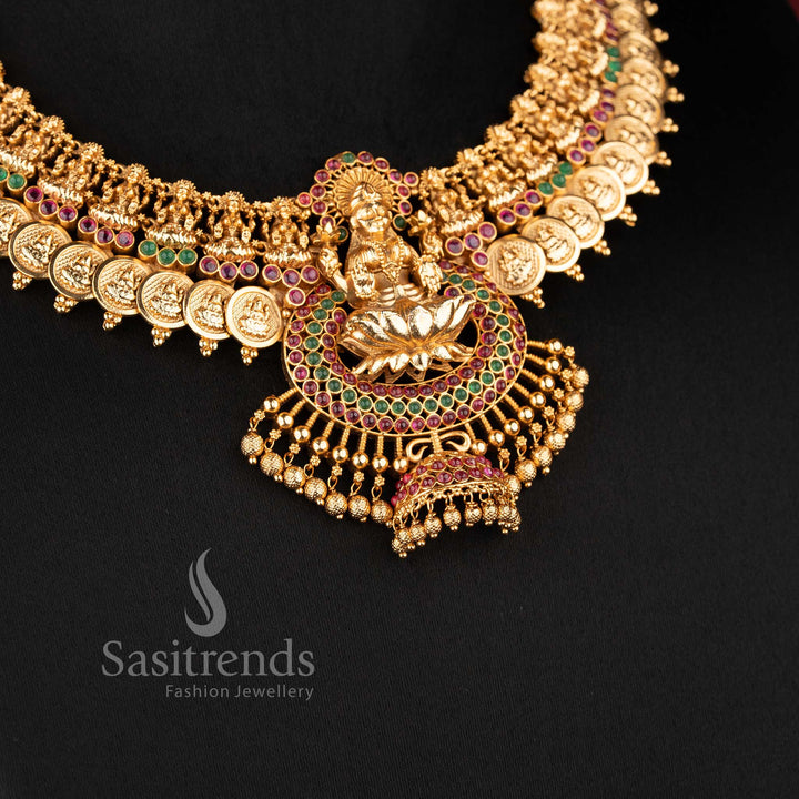 Traditional temple jewellery necklace set with Lakshmi lotus and kasu design in ruby green color and matte gold tone by Sasitrends for bridal wear