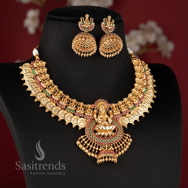 Traditional temple jewellery necklace set with Lakshmi lotus and kasu design in ruby color and matte gold tone by Sasitrends for bridal wear