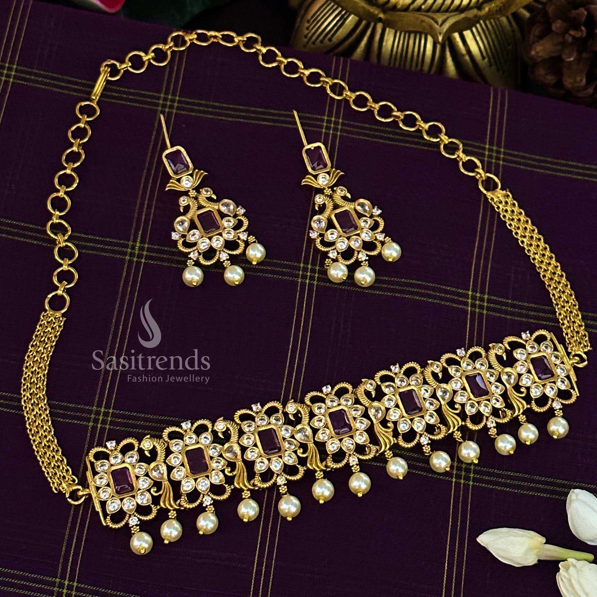 Elegant ruby temple choker jewellery set adorned with a graceful peacock motif, designer matte gold finish, and shimmering AD accents for traditional women – Sasitrends