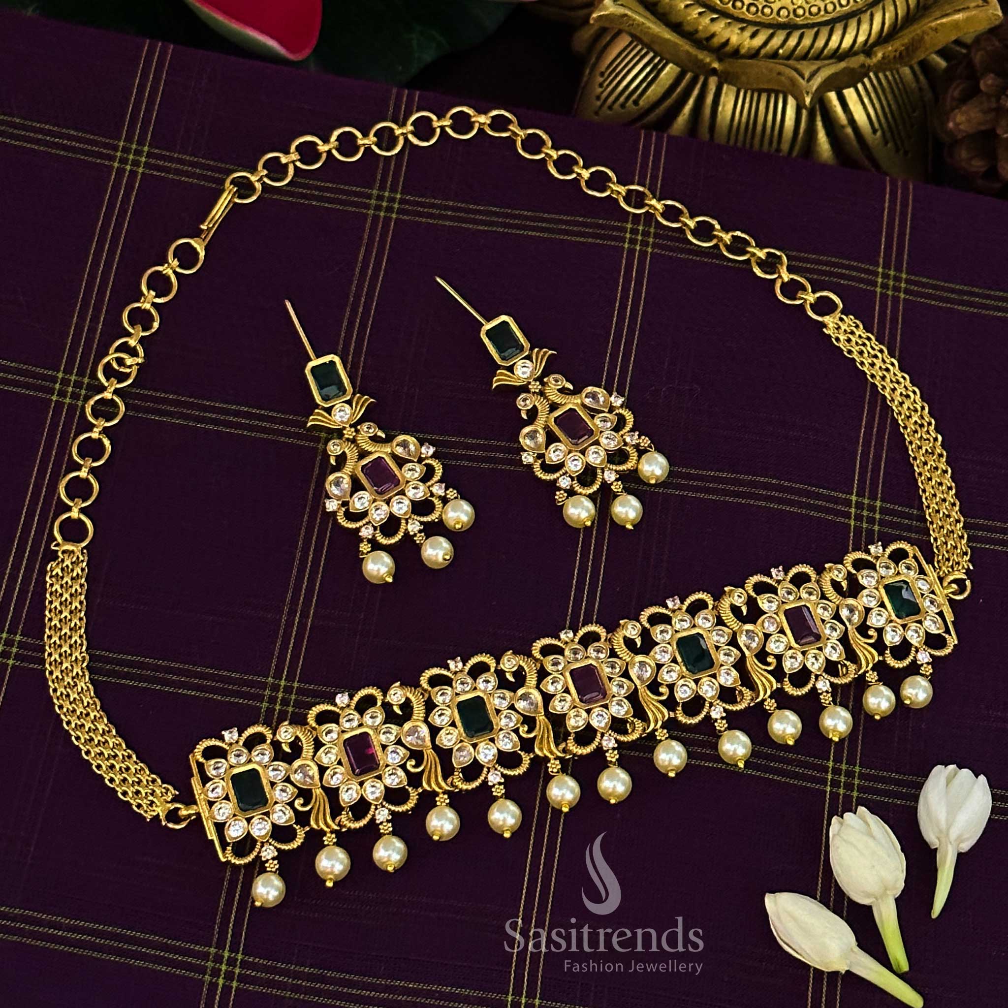 Striking ruby-green combination temple choker jewellery set with iconic peacock centrepiece, matte gold finish and sparkling AD crystal stones for celebration style – Sasitrends